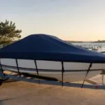 20 ft trailerable boat with a fitted navy boat cover on a trailer