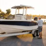 Boat owner measuring a trailerable boat for cover fit